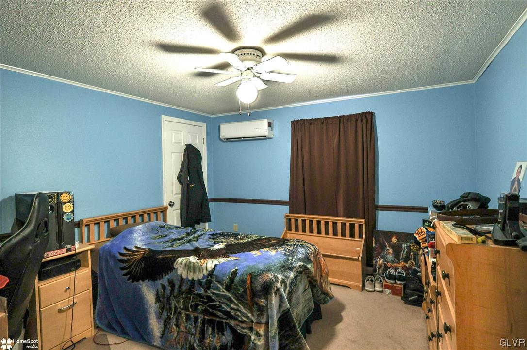 7197 Borman Road New Tripoli, PA 18066 - Photo 19 of 30 a bedroom with a bed and a chandelier
