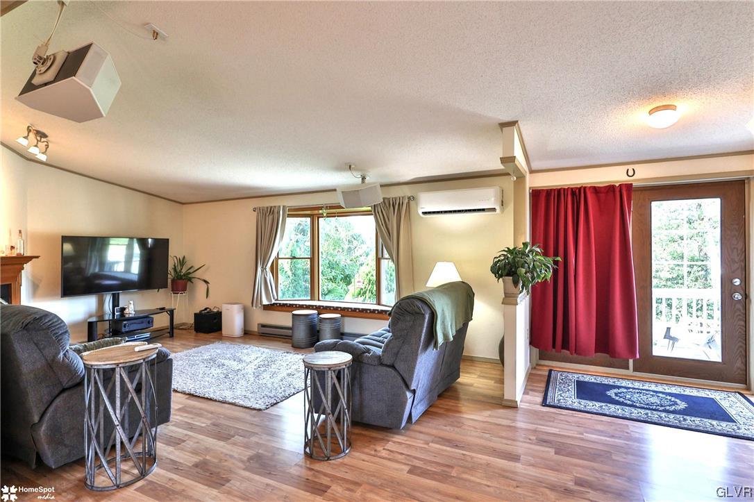 7197 Borman Road New Tripoli, PA 18066 - Photo 3 of 30 a living room with furniture a flat screen tv and a window