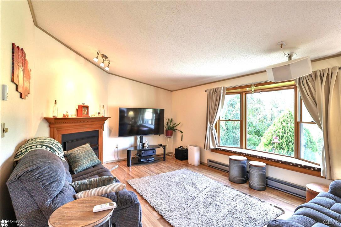 7197 Borman Road New Tripoli, PA 18066 - Photo 4 of 30 a living room with furniture and a flat screen tv
