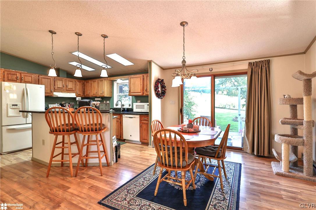 7197 Borman Road New Tripoli, PA 18066 - Photo 7 of 30 a dining room with furniture a chandelier and wooden floor