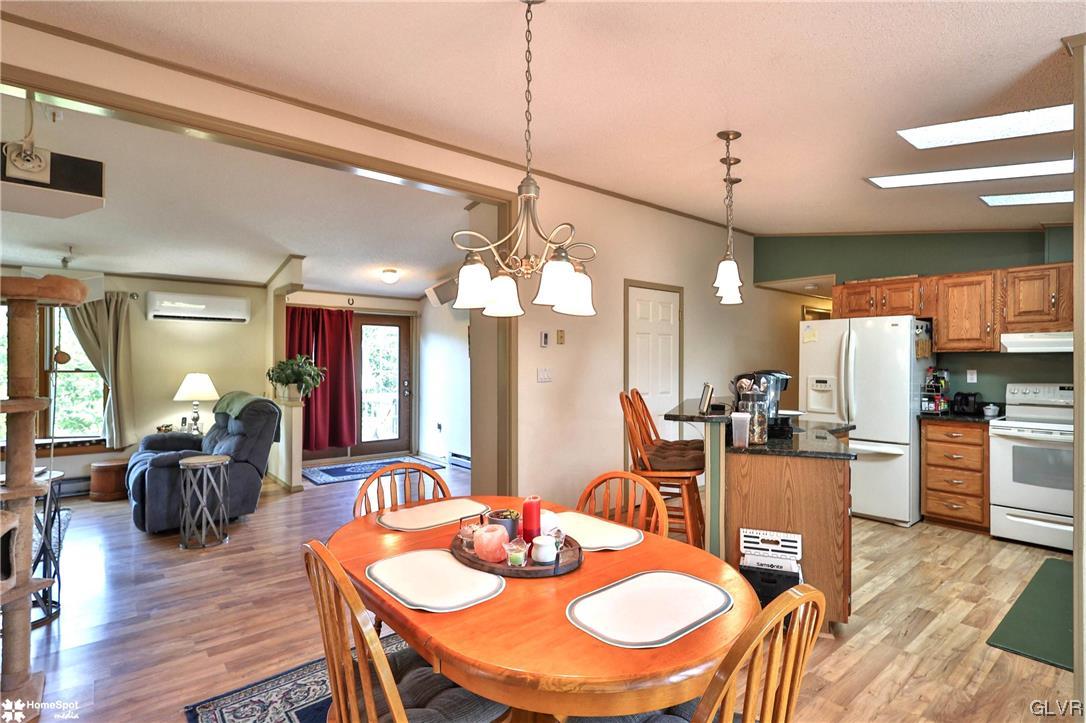 7197 Borman Road New Tripoli, PA 18066 - Photo 8 of 30 a view of a dining room and livingroom with furniture wooden floor a chandelier