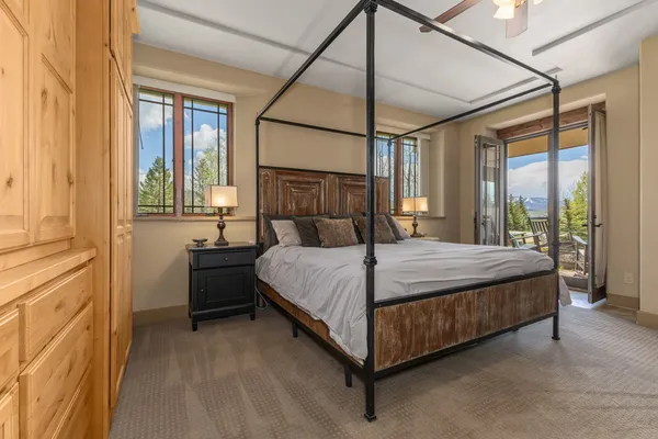 a bedroom with a large bed and a balcony view