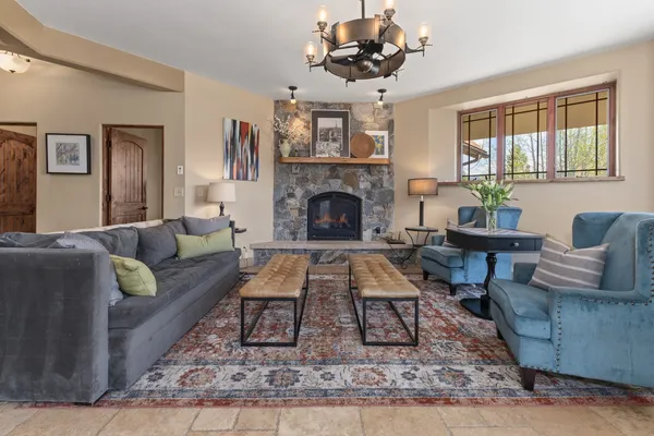 a living room with furniture a dining table and a fireplace