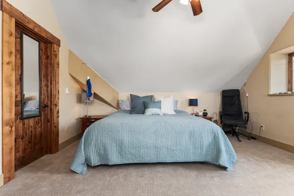 a bedroom with a bed and a chandelier