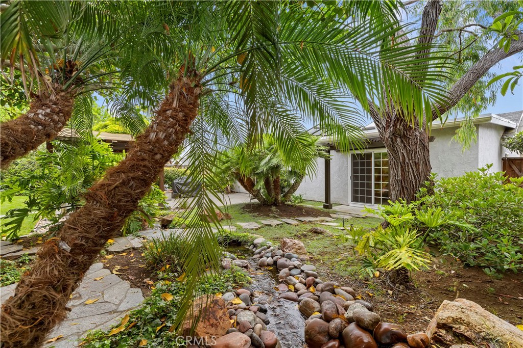 129 5 Crowns Way Encinitas, CA 92024 - Photo 31 of 43 view with stream corner rear of property