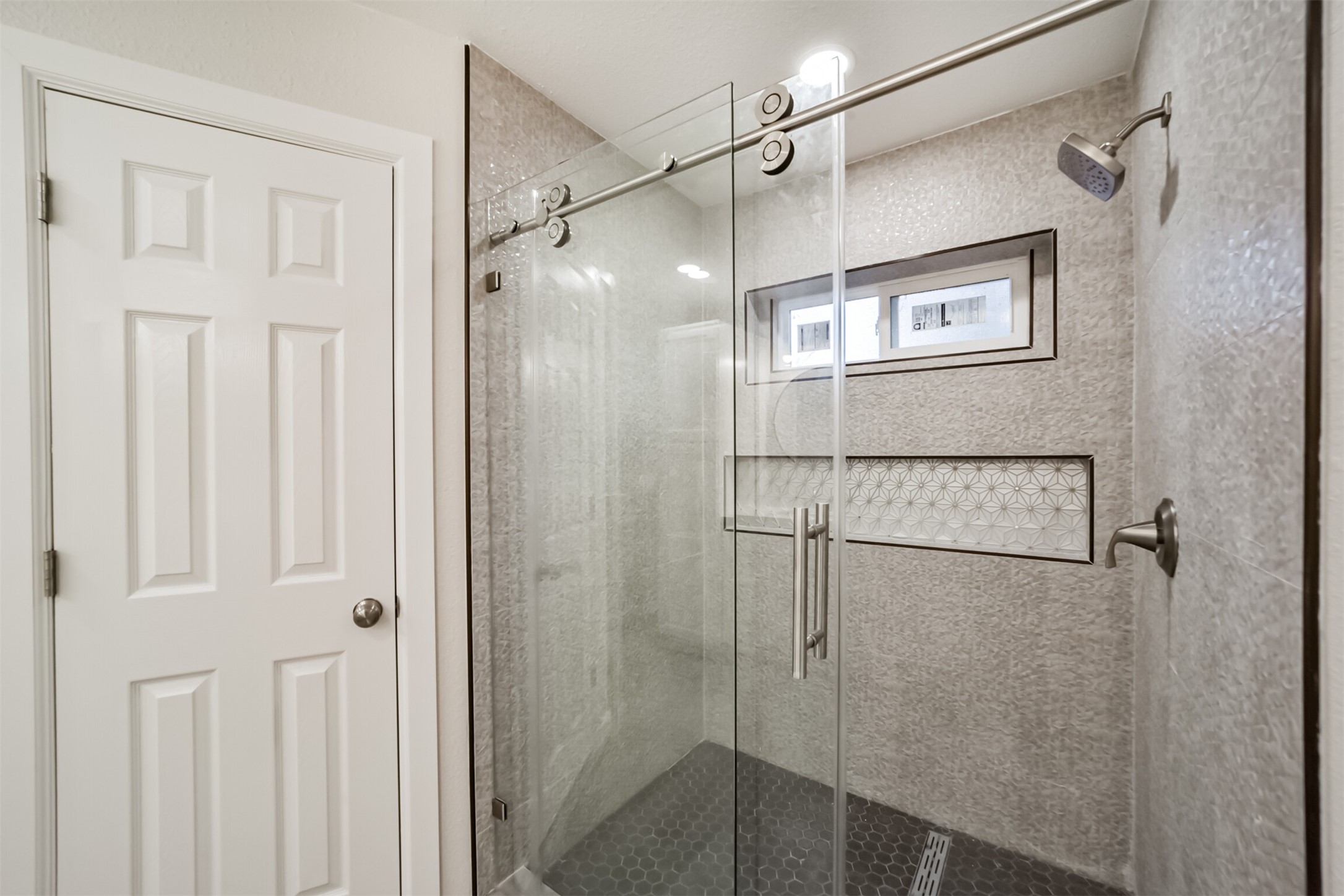15610 Ripplewind Lane Houston, TX 77068 - Photo 24 of 44 a bathroom with a glass shower door