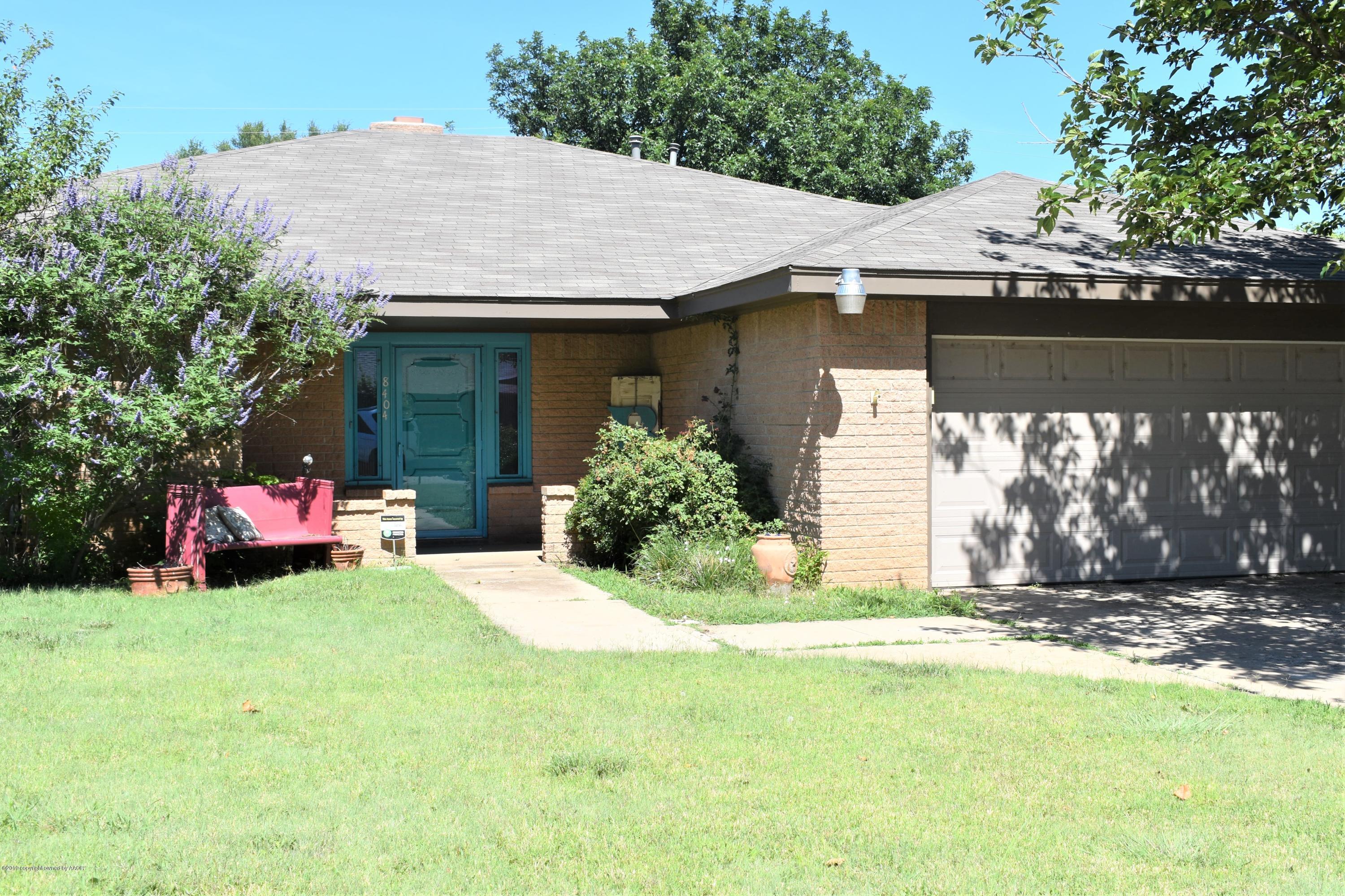 a view of a house with a yard and garage