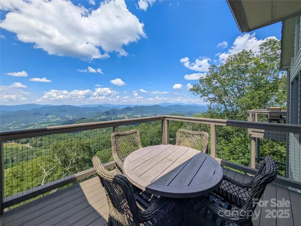 a view of a balcony with mountain view and wooden floor