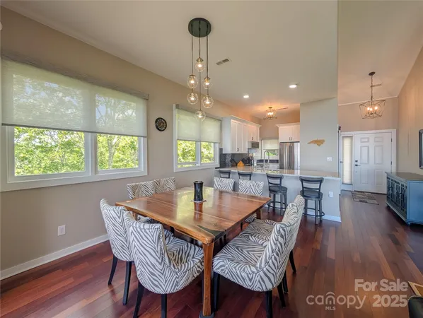 a dining room with furniture window and wooden floor