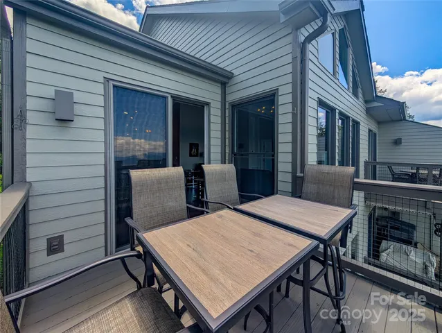 a balcony with furniture and a fireplace
