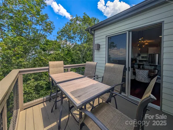 a view of balcony with wooden floor and seating space