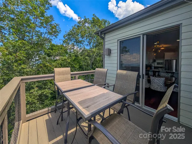 a view of balcony with wooden floor and seating space
