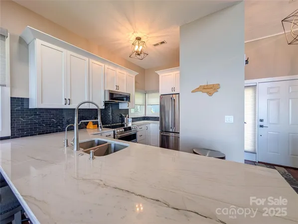 a kitchen with refrigerator and cabinets