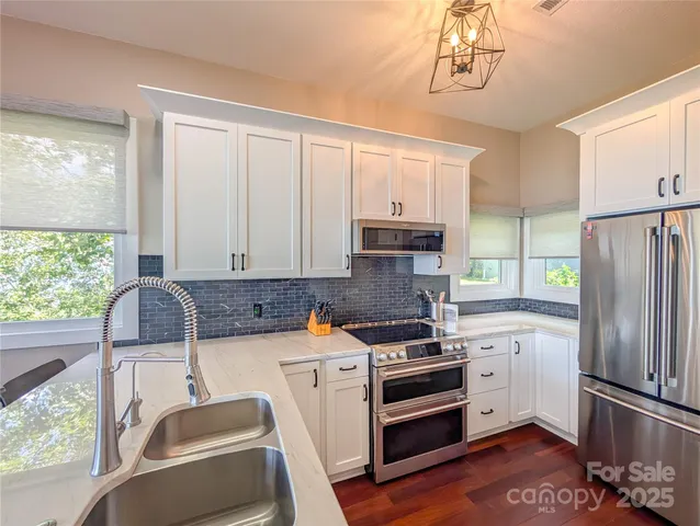 a kitchen with a stove a sink and a refrigerator