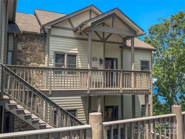 a view of a house with wooden fence