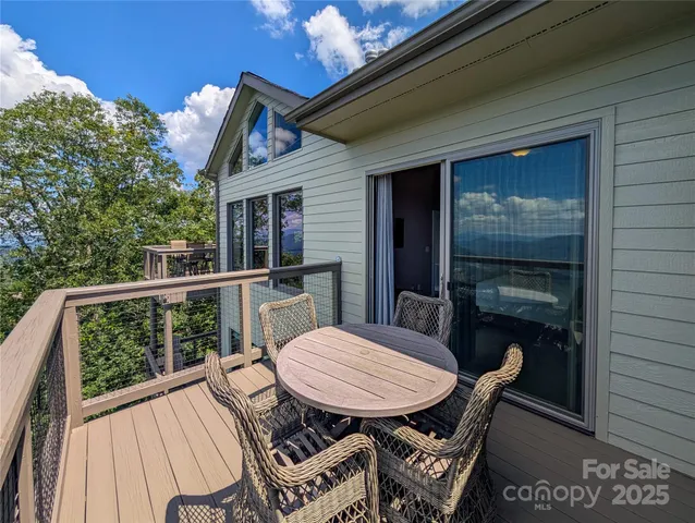 a view of a balcony with a table and chairs