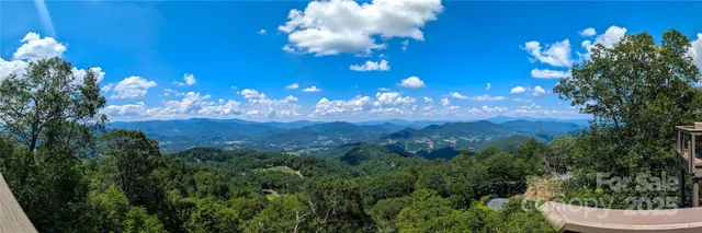 a view of a fountain in middle of the green field
