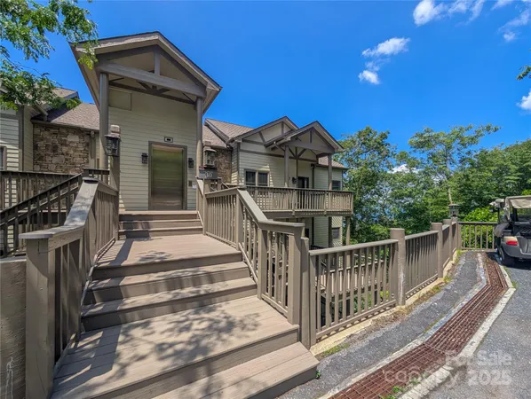 a view of a house with wooden fence