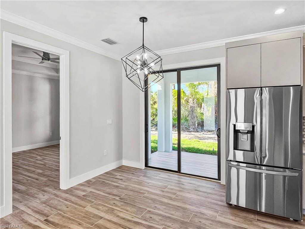 2997 28th Avenue Southeast Naples, FL 34117 - Photo 12 of 49 a kitchen with stainless steel appliances granite countertop a refrigerator and a window