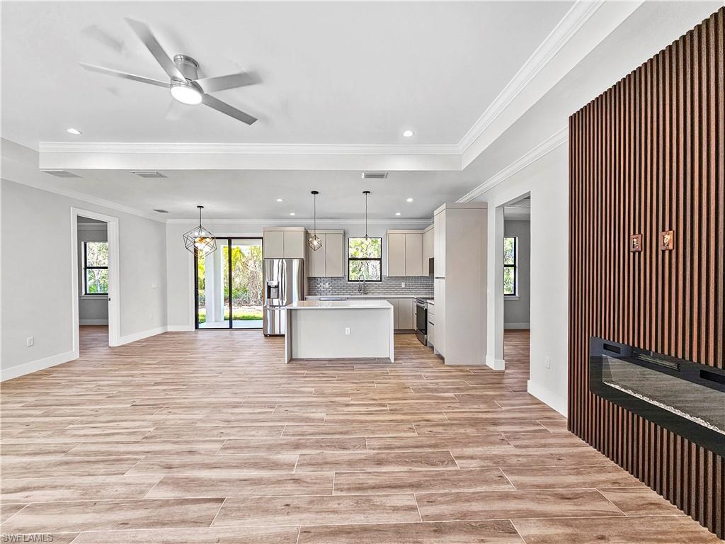 2997 28th Avenue Southeast Naples, FL 34117 - Photo 13 of 49 a view of an empty room with wooden floor and a window