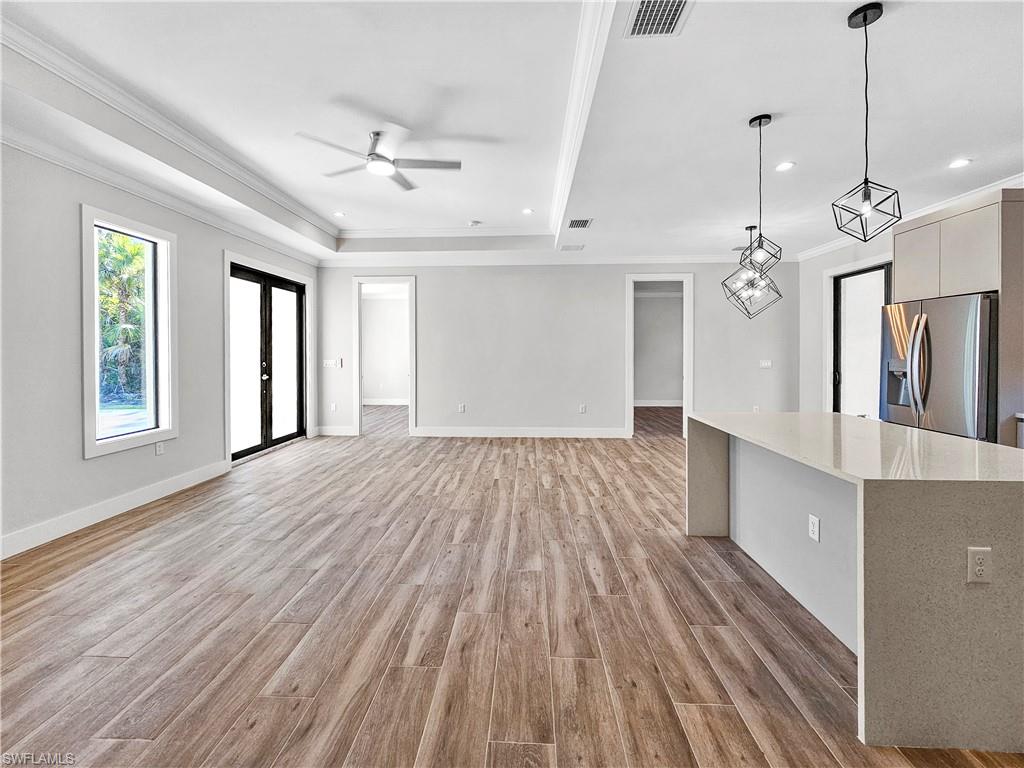 2997 28th Avenue Southeast Naples, FL 34117 - Photo 16 of 49 a view of empty room with wooden floor and fan