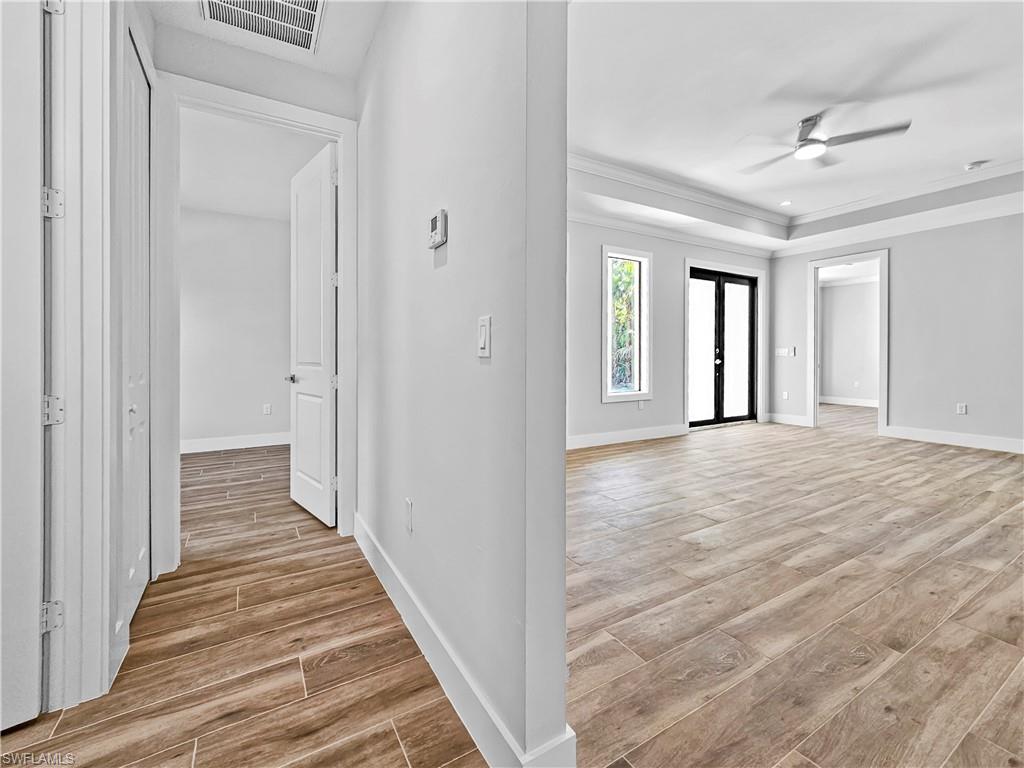 2997 28th Avenue Southeast Naples, FL 34117 - Photo 19 of 49 a view of a hallway view with wooden floor and staircase