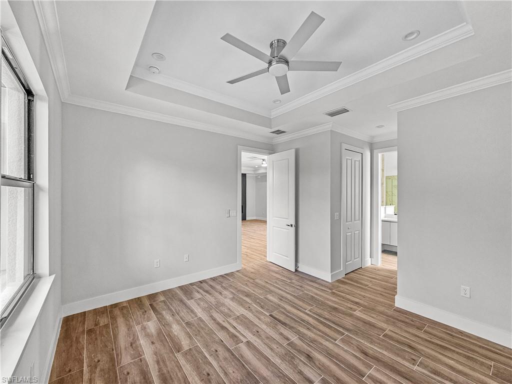 2997 28th Avenue Southeast Naples, FL 34117 - Photo 20 of 49 a view of empty room with wooden floor and fan