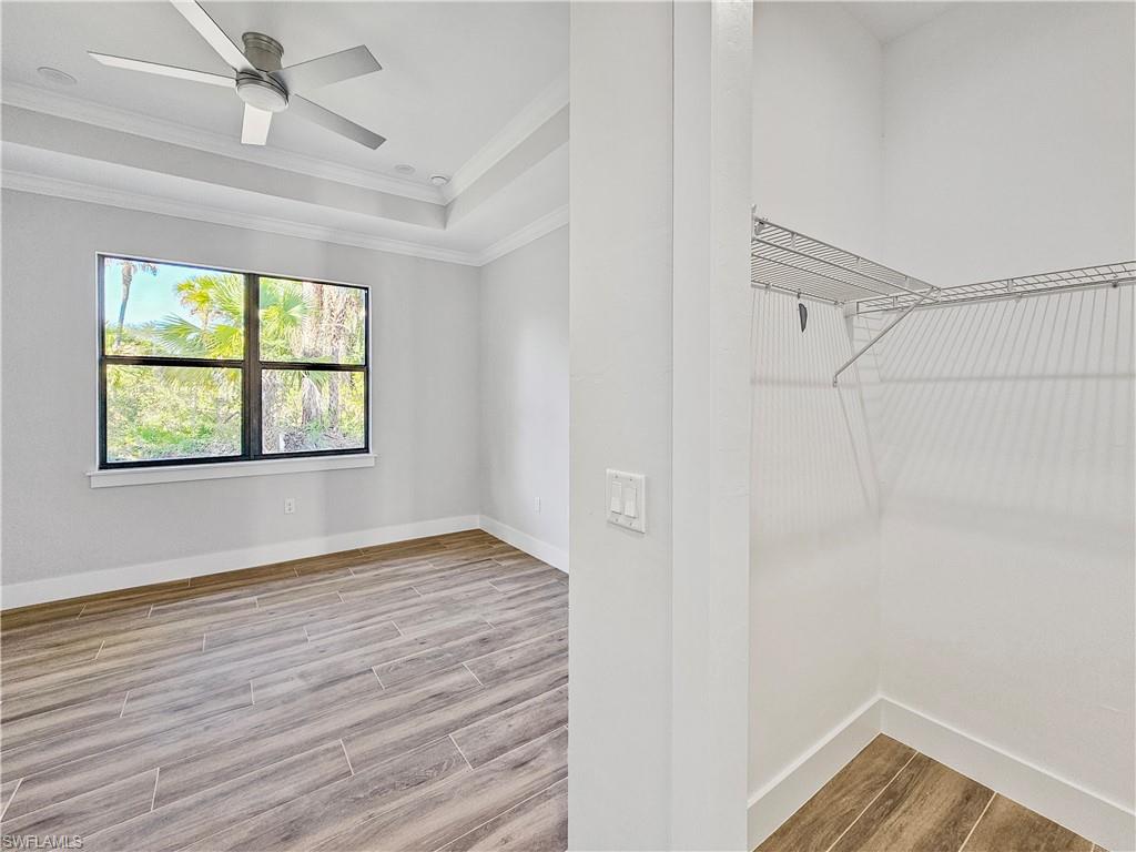 2997 28th Avenue Southeast Naples, FL 34117 - Photo 21 of 49 wooden floor in an empty room with a window