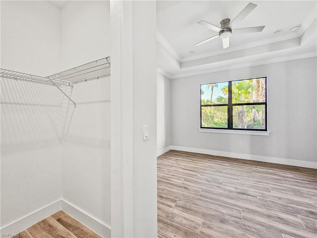 2997 28th Avenue Southeast Naples, FL 34117 - Photo 22 of 49 a view of an empty room with a window and wooden floor