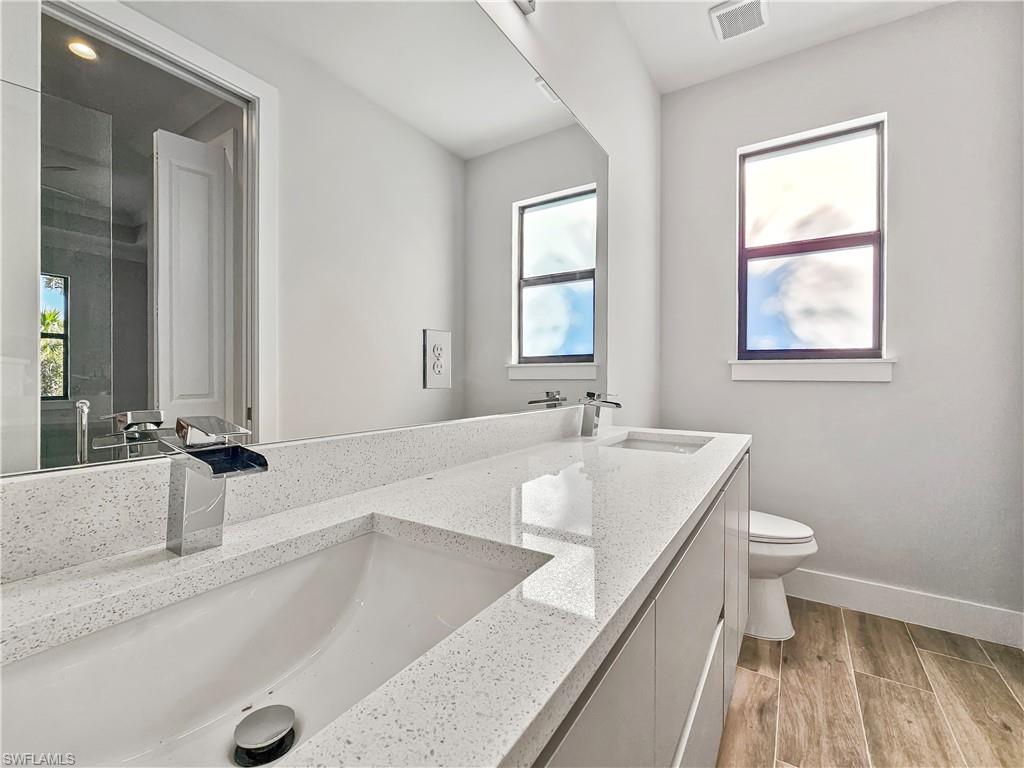 2997 28th Avenue Southeast Naples, FL 34117 - Photo 25 of 49 a large bathroom with a tub a sink and a large mirror