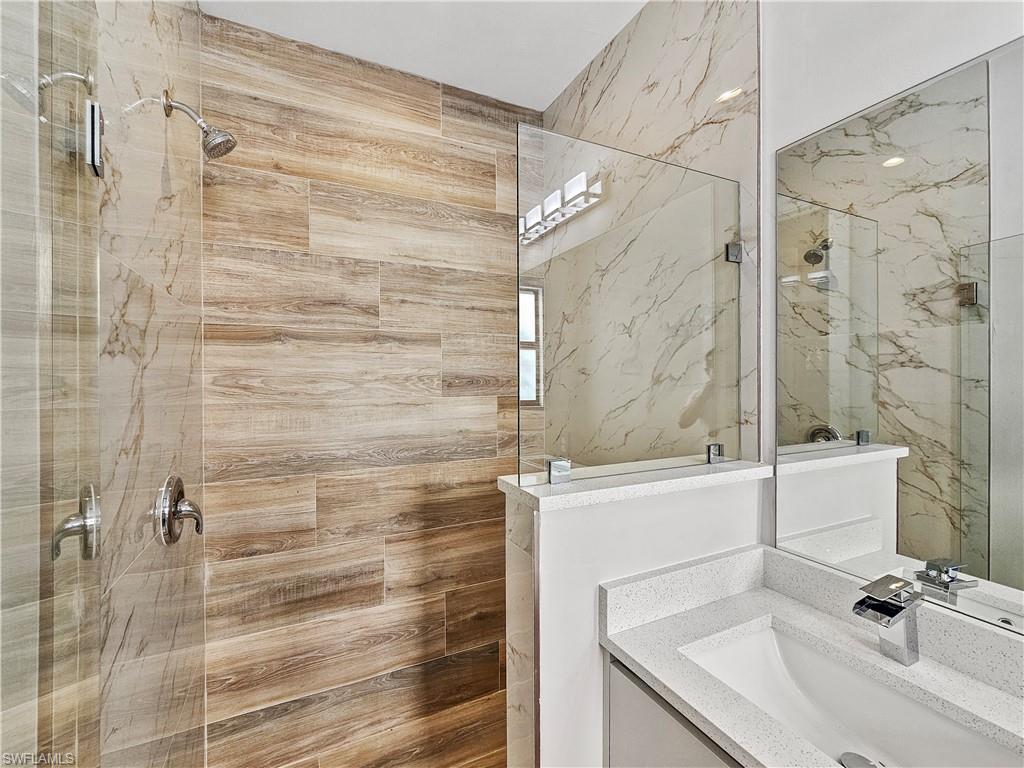 2997 28th Avenue Southeast Naples, FL 34117 - Photo 26 of 49 a bathroom with a sink and a shower