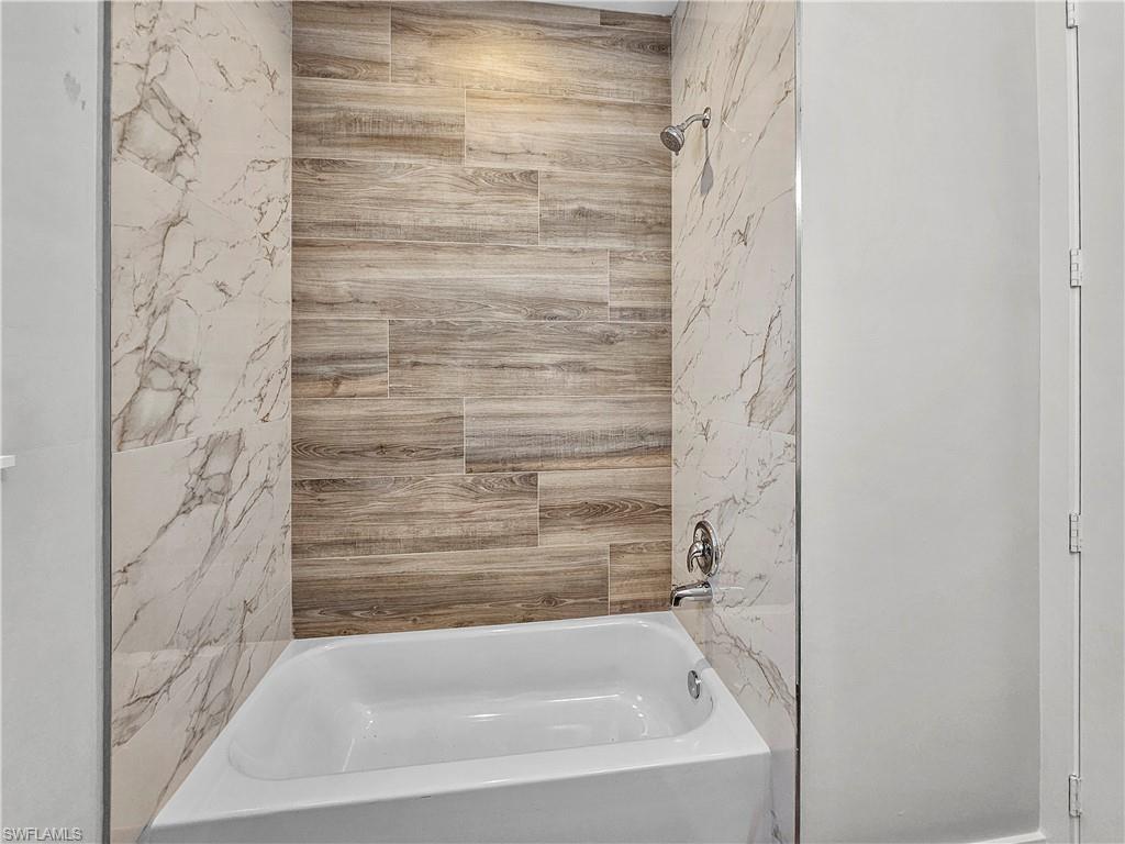 2997 28th Avenue Southeast Naples, FL 34117 - Photo 32 of 49 a bathroom with a bathtub