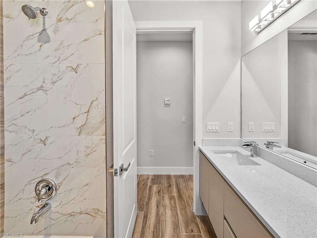 2997 28th Avenue Southeast Naples, FL 34117 - Photo 33 of 49 a bathroom with a double vanity sink and mirror