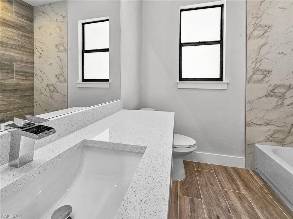 2997 28th Avenue Southeast Naples, FL 34117 - Photo 34 of 49 a bathroom with a sink toilet and shower