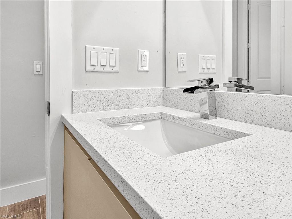 2997 28th Avenue Southeast Naples, FL 34117 - Photo 35 of 49 a view of a kitchen counter top a sink and cabinets