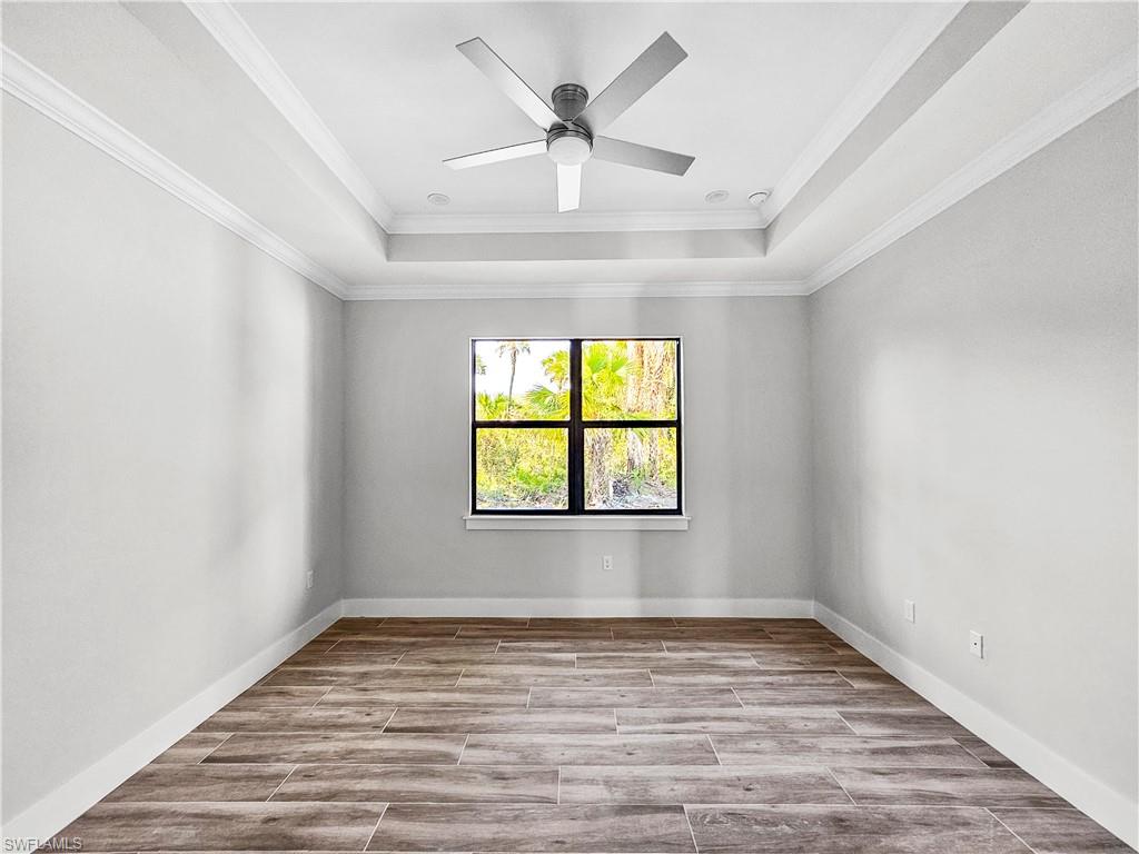 2997 28th Avenue Southeast Naples, FL 34117 - Photo 37 of 49 wooden floor in an empty room with a window