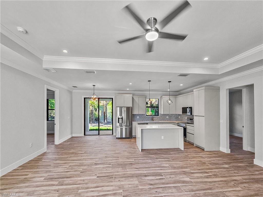 2997 28th Avenue Southeast Naples, FL 34117 - Photo 4 of 49 a view of a kitchen with a sink cabinets and wooden floor