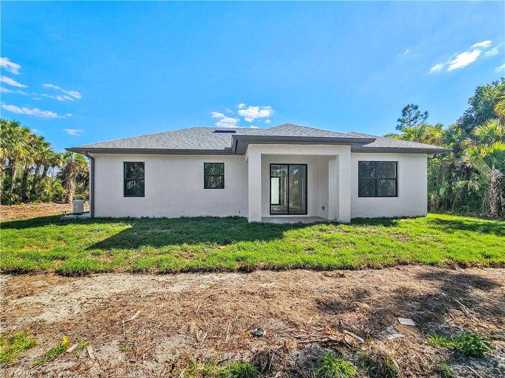 2997 28th Avenue Southeast Naples, FL 34117 - Photo 42 of 49 a view of a house with a yard