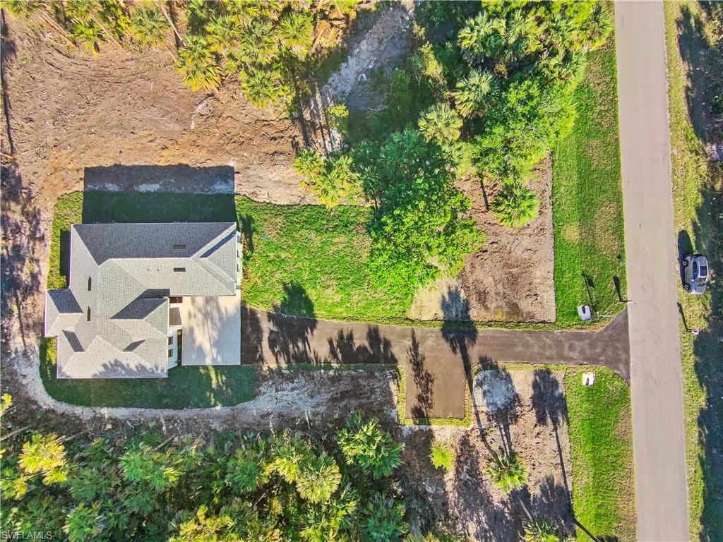 2997 28th Avenue Southeast Naples, FL 34117 - Photo 44 of 49 an aerial view of a house with a yard and large trees