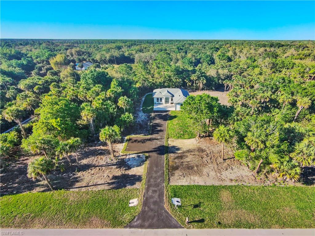 2997 28th Avenue Southeast Naples, FL 34117 - Photo 49 of 49 an aerial view of a house with a yard and lake view