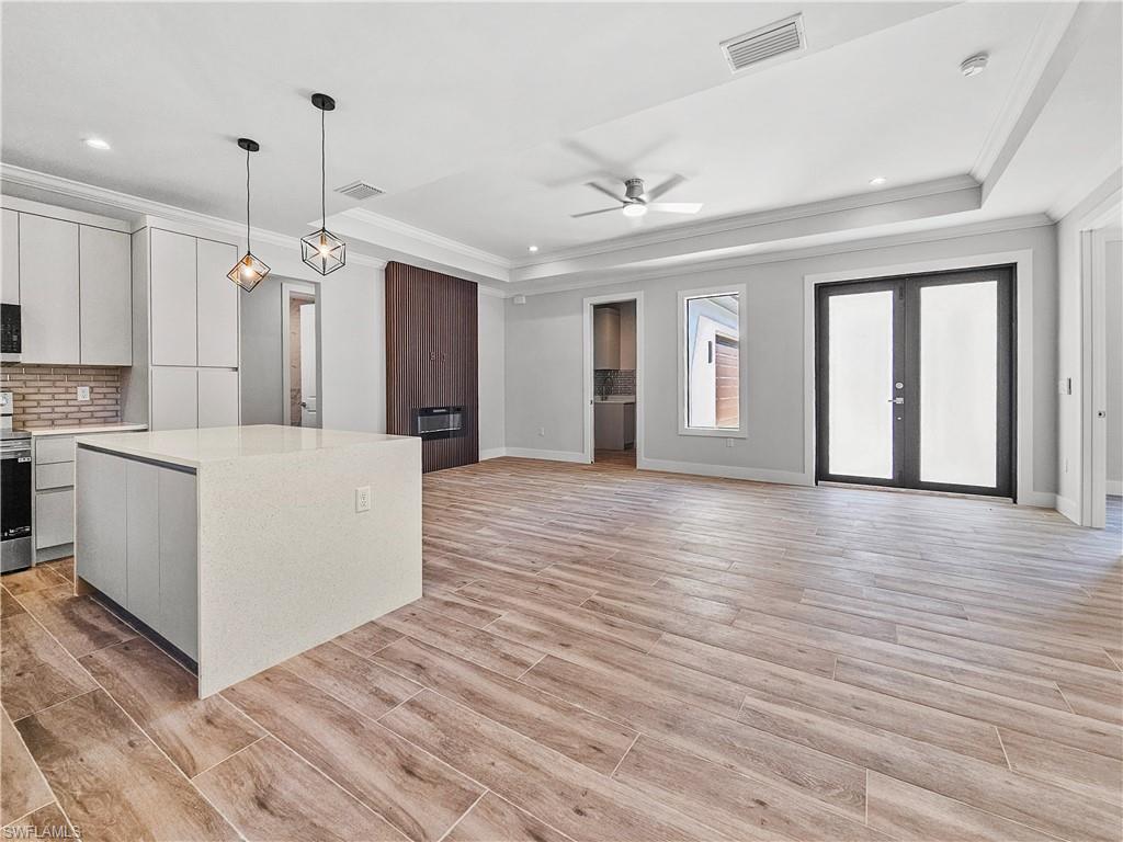 2997 28th Avenue Southeast Naples, FL 34117 - Photo 7 of 49 a view of a kitchen with wooden floor and a kitchen space