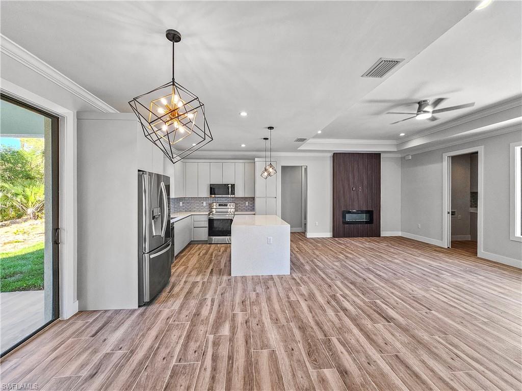 2997 28th Avenue Southeast Naples, FL 34117 - Photo 8 of 49 a view of a kitchen with furniture and a ceiling fan