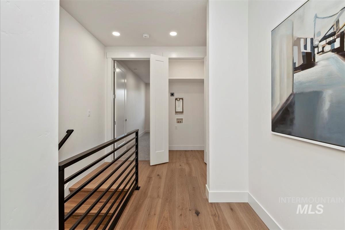 3243 West Moore Street Boise, ID 83702 - Photo 12 of 38 Hallway featuring light wood finished floors, an upstairs landing, and recessed lighting