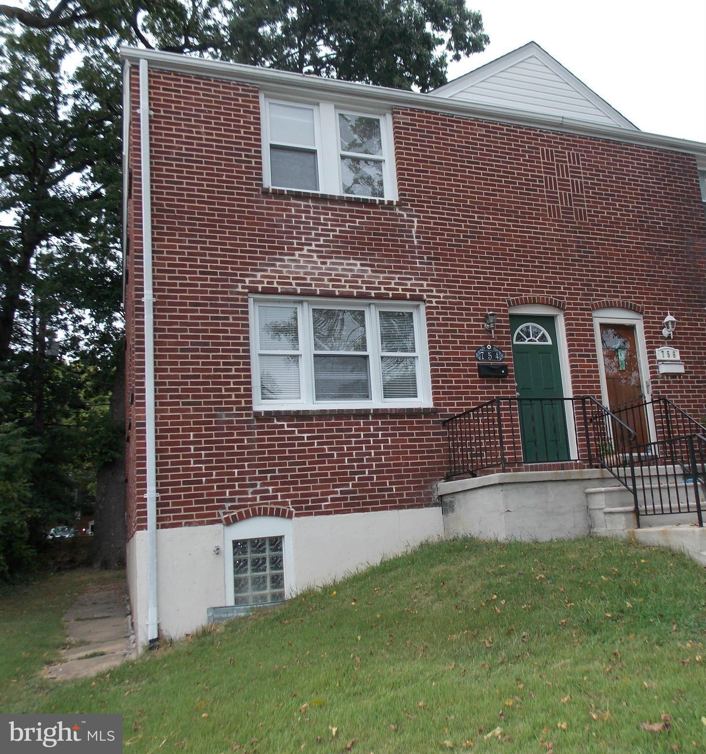754 Charing Cross Road Baltimore, MD 21229 - Photo 1 of 15 a front view of a house with a yard