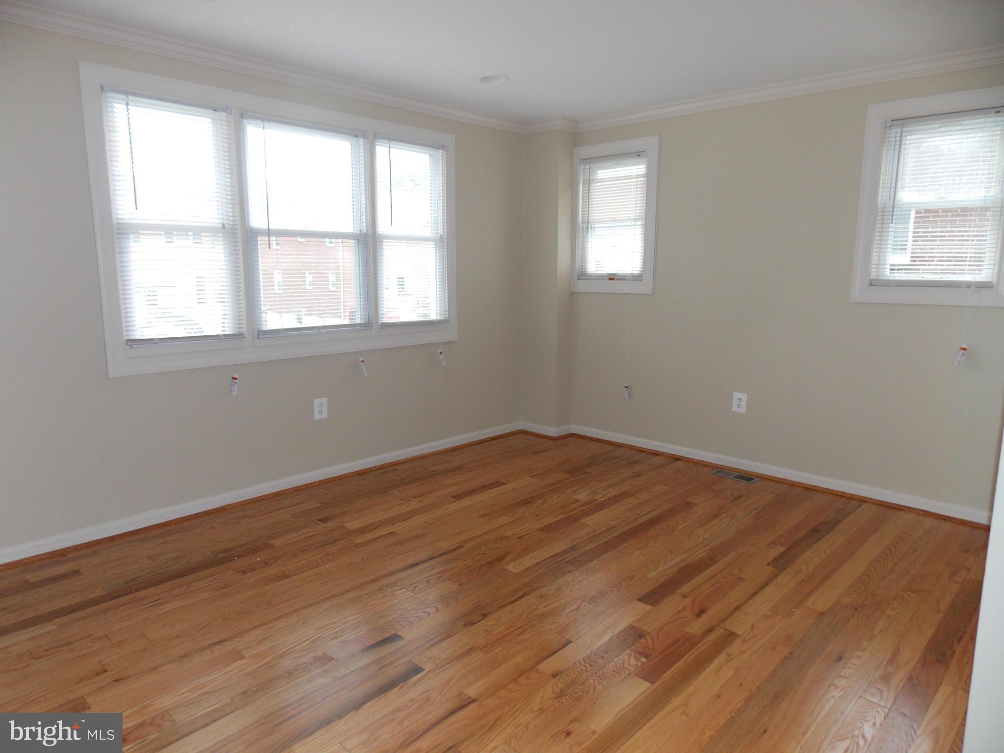 754 Charing Cross Road Baltimore, MD 21229 - Photo 2 of 15 a view of empty room with wooden floor and fan