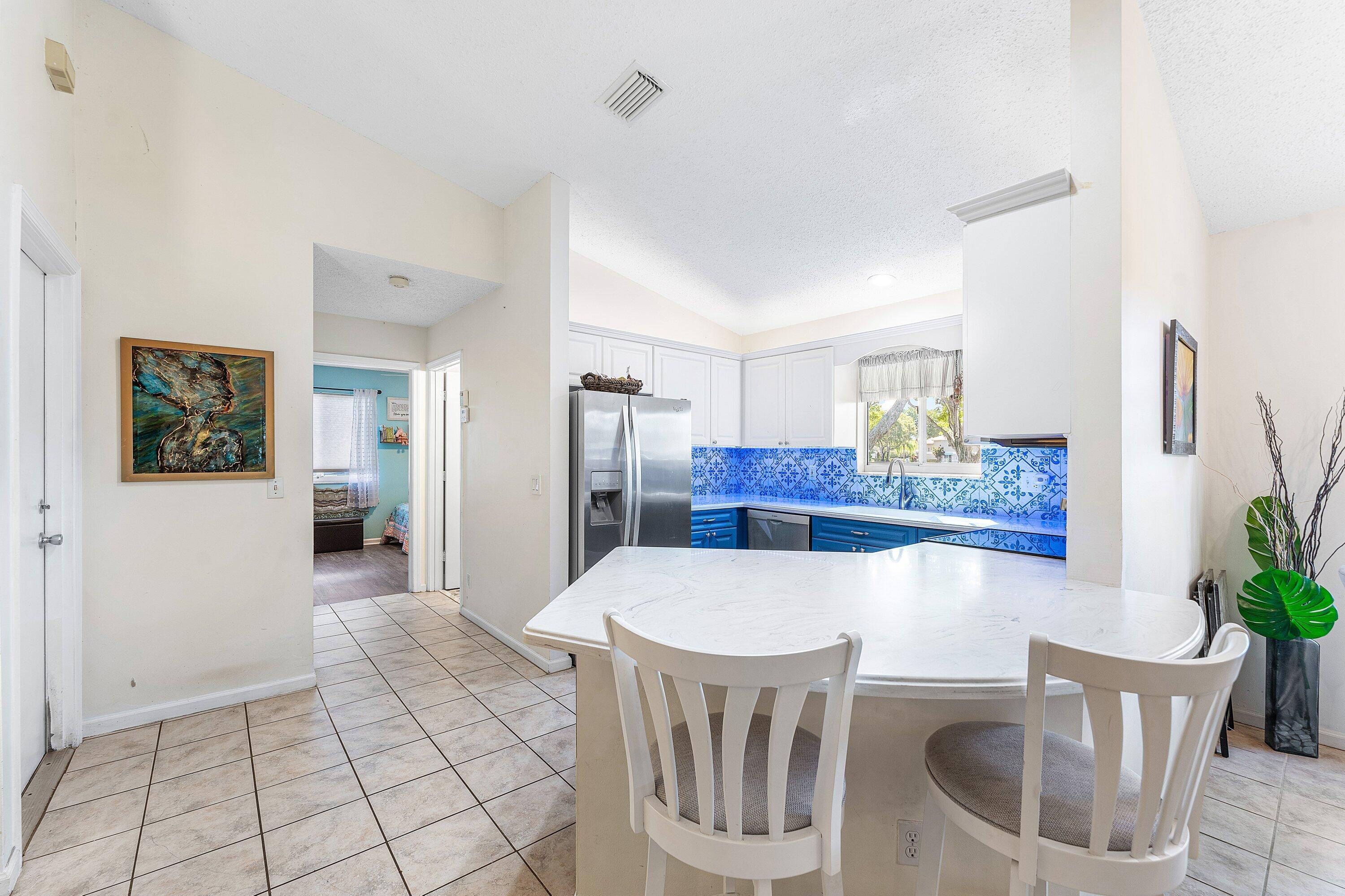 9112 Vineland Court, Unit A Boca Raton, FL 33496 - Photo 18 of 62 a view of a dining room with furniture