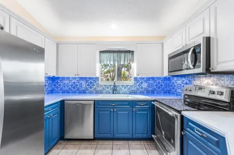 a kitchen with a stove a microwave and wooden cabinets