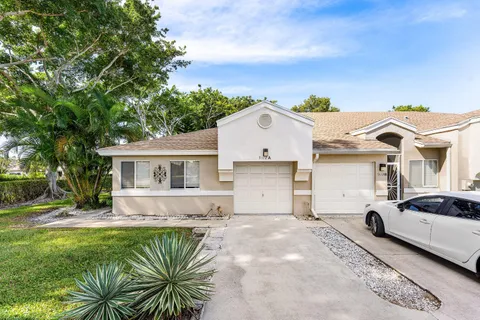 a view of a house with a backyard