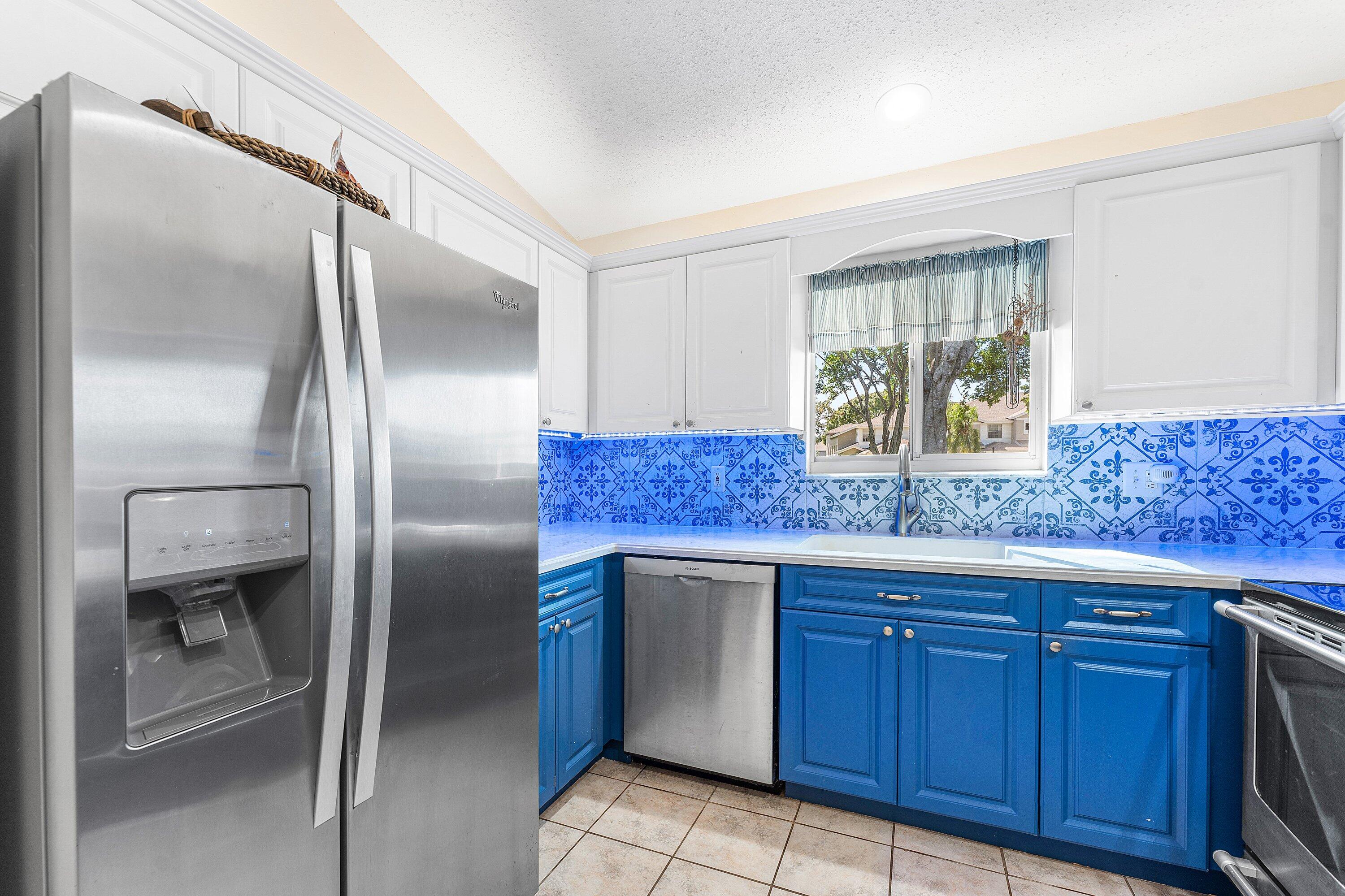 9112 Vineland Court, Unit A Boca Raton, FL 33496 - Photo 21 of 62 a kitchen with stainless steel appliances granite countertop a refrigerator and a sink