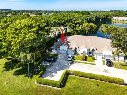 an aerial view of a house with a yard and garden